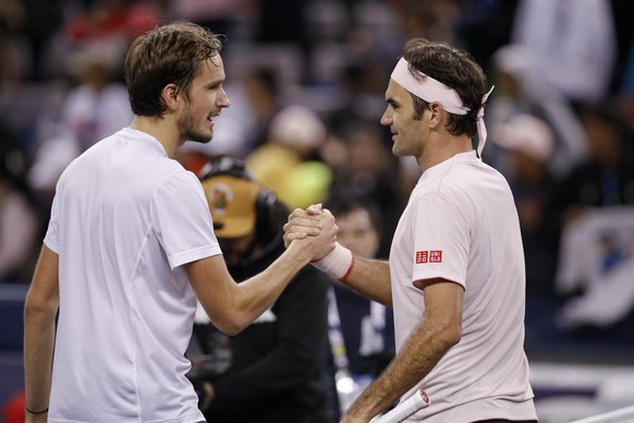 Roger Federer of Switzerland, right, shakes hands with Daniil Medvedev of Russia after their men&#039;s singles match of the Shanghai Masters tennis tournament at Qizhong Forest Sports City Tennis Cen ...