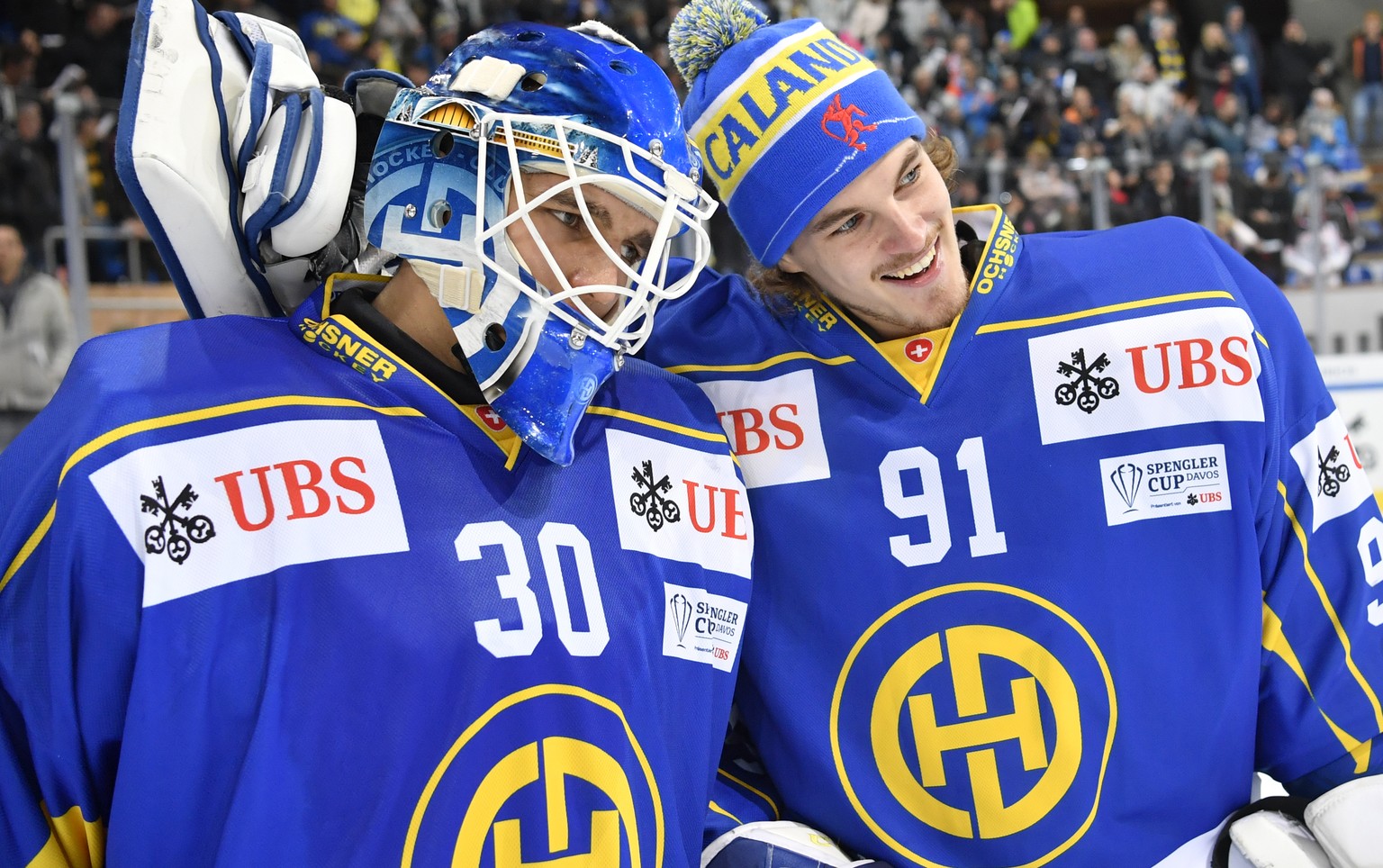 Davos&#039; Joren van Pottelberghe, left, and goalkeeper Gilles Senn celebrate after winning the game between HC Davos and Mountfield HK at the 91th Spengler Cup ice hockey tournament in Davos, Switze ...