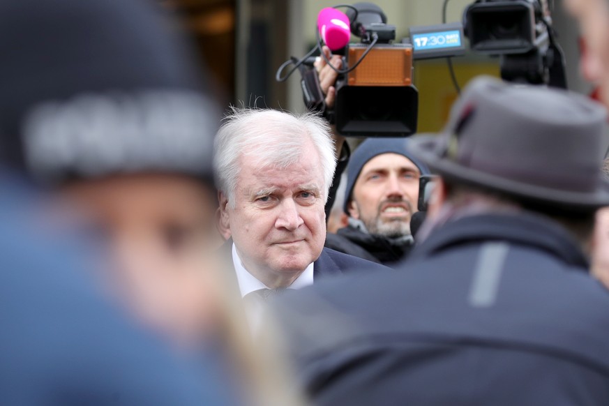epa08230874 German Interior Minister Horst Seehofer looks on as he visits the scene in the wake of two deadly shootings in Hanau, Germany, 20 February 2020. At least nine people were killed in two sho ...