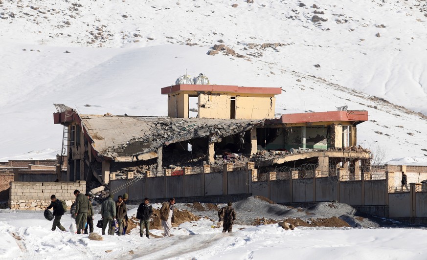 epa07306335 Afghan intelligence officers leave the collapsed building of Afghanistan&#039;s intelligence office following an attack in Wardak, Afghanistan, 21 January 2019. A Taliban Humvee tank full  ...
