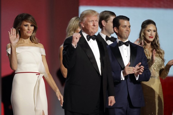 FILE - In this Jan. 20, 2017, file photo President Donald Trump, center, raises his fist alongside first lady Melania Trump, left, and son Donald Trump, Jr., after dancing at the Liberty Ball followin ...