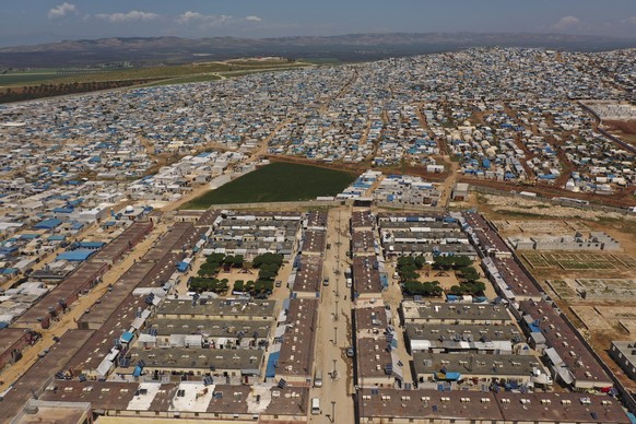 FILE - In this April 19, 2020 photo file photo, shows a large refugee camp on the Syrian side of the border with Turkey, near the town of Atma, in Idlib province, Syria. Over the last two days, member ...