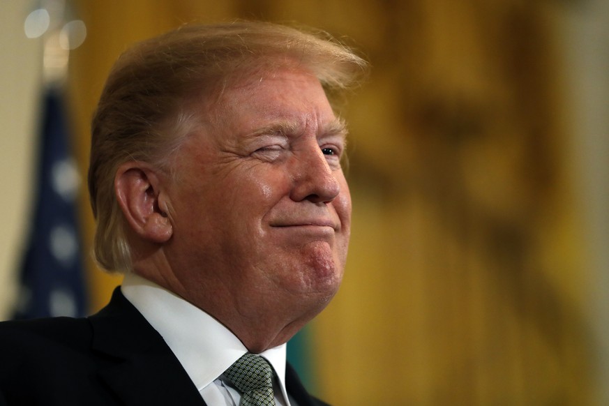 President Donald Trump winks during the annual presentation of a bowl of shamrocks with Irish Prime Minister Leo Varadkar, Thursday, March 14, 2019, in the East Room of the White House in Washington.  ...