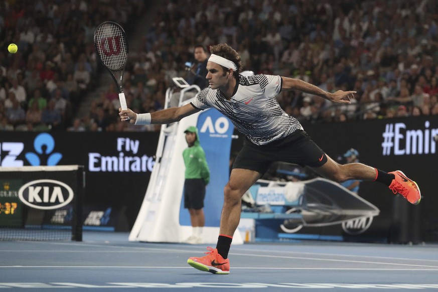Switzerland&#039;s Roger Federer makes a backhand return to Spain&#039;s Rafael Nadal in the men&#039;s singles final at the Australian Open tennis championships in Melbourne, Australia, Sunday, Jan.  ...