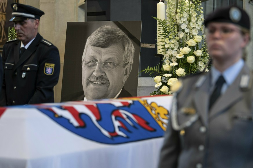 FILE-In this June 13, 2019 file photo a picture of Walter Luebcke stands behind his coffin during the funeral service in Kassel, Germany. Germany&#039;s top security official says the far-right extrem ...