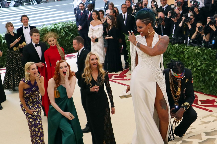 2 Chainz, kneeling center, and Kesha Ward, standing center, arrive at The Metropolitan Museum of Art&#039;s Costume Institute benefit gala celebrating the opening of the Heavenly Bodies: Fashion and t ...