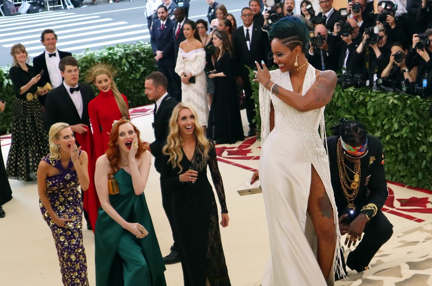 2 Chainz, kneeling center, and Kesha Ward, standing center, arrive at The Metropolitan Museum of Art's Costume Institute benefit gala celebrating the opening of the Heavenly Bodies: Fashion and t ...