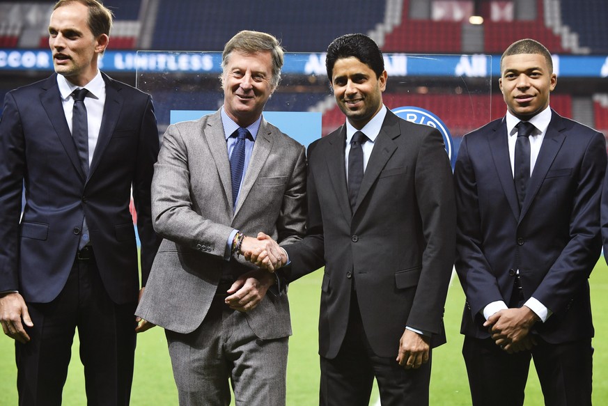 epa07388842 Accor Group CEO Sebastien Bazin (2-L) and Paris Saint-Germain (PSG) president and CEO Nasser Al-Khelaifi (2-R) shake hands next to PSG head coach Thomas Tuchel (L) and Kylian Mbappe (R) du ...