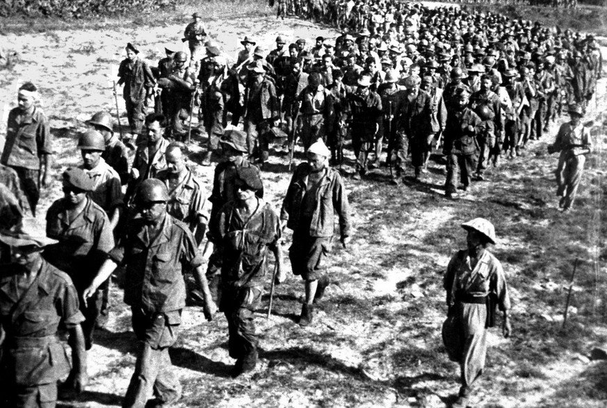 Captured French soldiers are marched through the fields after their surrender at Dien Bien Phu in 1954. More than 10&#039;000 French troops were captured after a 55 day siege, the French defeat ended  ...