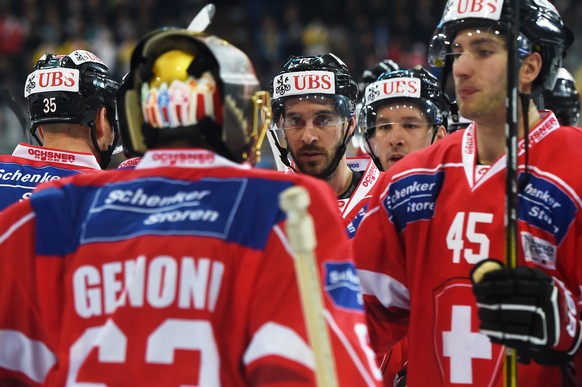 Team Suisse player Luca Cunti, Patrick Geering and the team celebrate after winning the game between Team Suisse and Dinamo Riga at the 91th Spengler Cup ice hockey tournament in Davos, Switzerland, T ...