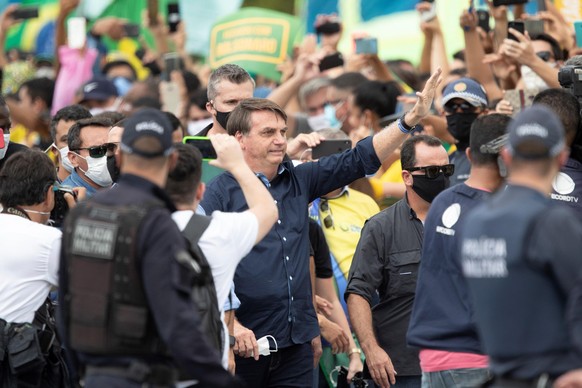 epa08442046 Brazilian president Jair Bolsonaro meets supporters during a demonstration, in Brasilia, Brazil, 24 May 2020. Hundreds of people supporting President Bolsonaro gathered around the Governme ...