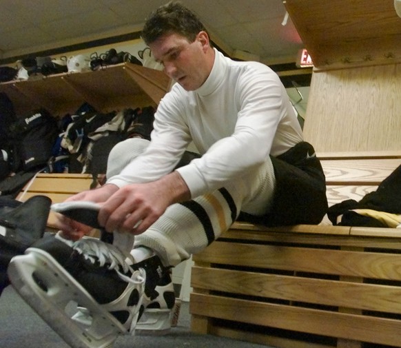 Pittsburgh Penguins Hall of Famer and owner, Mario Lemieux, takes off his skates after his first practice with the team at their practice facilities in Canonsburg, Pa., Tuesday, Dec. 19, 2000. Lemieux ...
