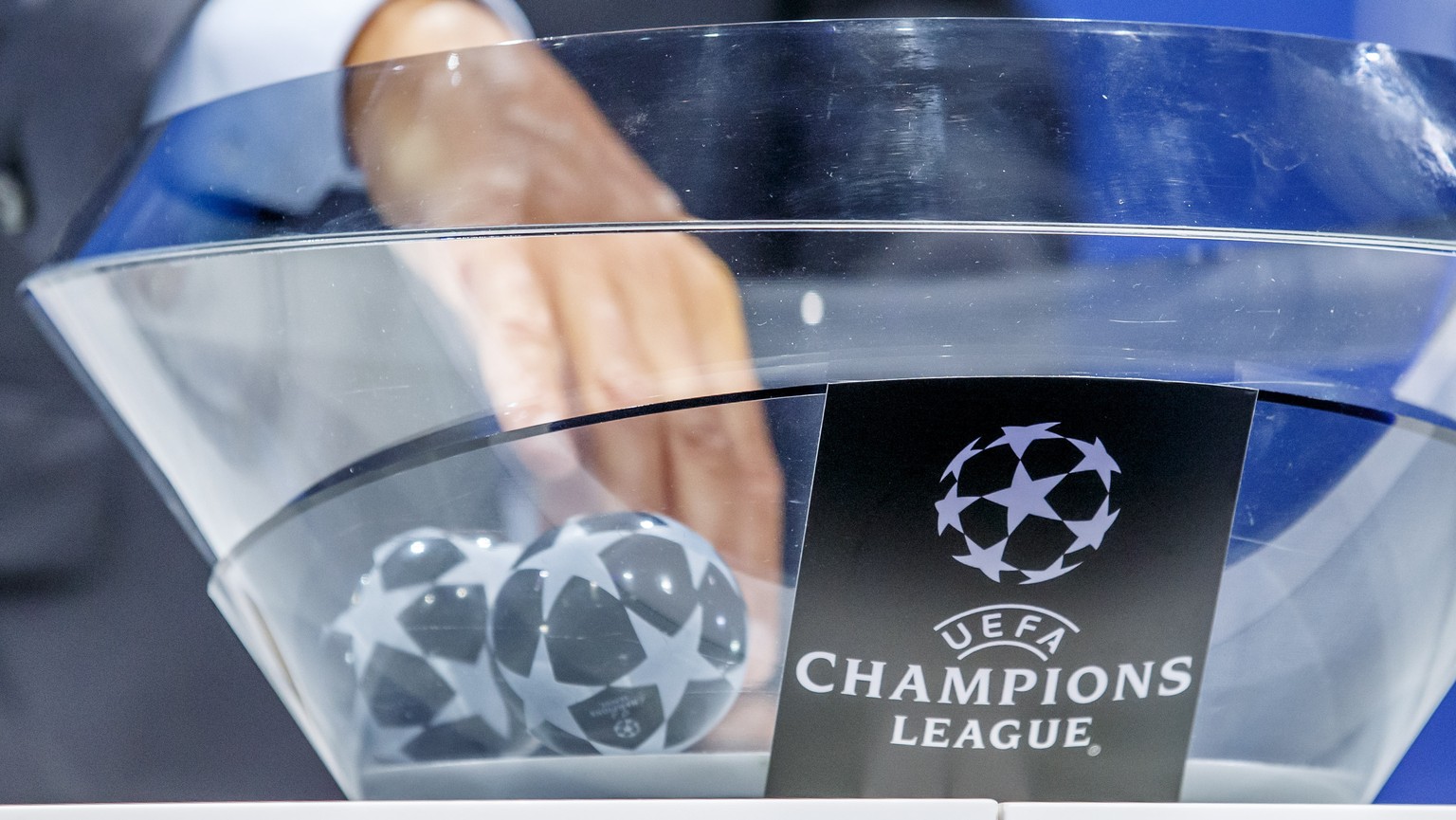 Michael Heselschwerdt, UEFA Head of Club Competition, removes the balls containing the names of the soccer clubs, during the drawing of the matches for the Champions League 2019/20 Play-offs round, at ...