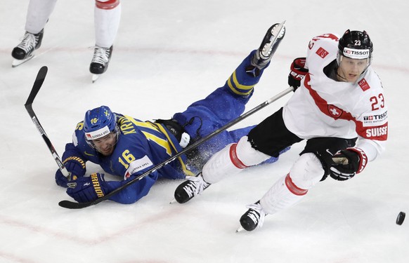 Sweden&#039;s Marcus Kruger, left, challenges for the puck Switzerland&#039;s Simon Bodenmann, right, during the Ice Hockey World Championships quarterfinal match between Switzerland and Sweden in the ...