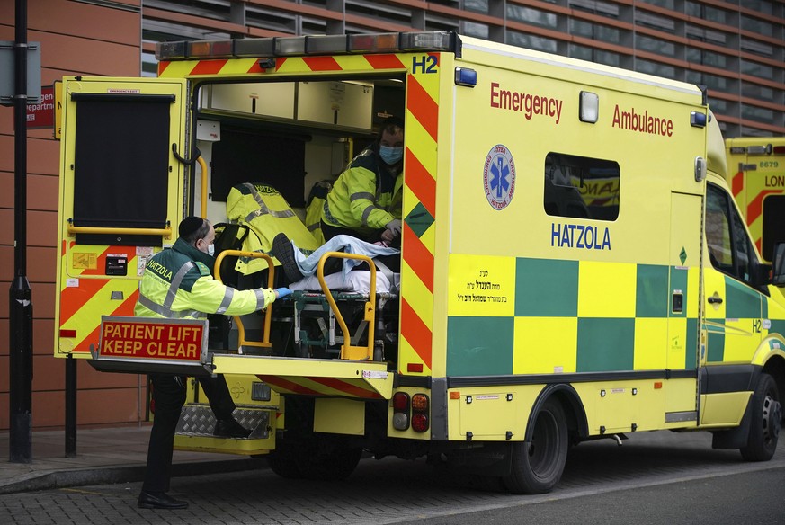 Paramedics transfer a patient from an ambulance into the Royal London Hospital, Friday Jan. 8, 2021. London&#039;s mayor Sadiq Khan declared the capital&#039;s COVID-19 situation to be critical Friday ...