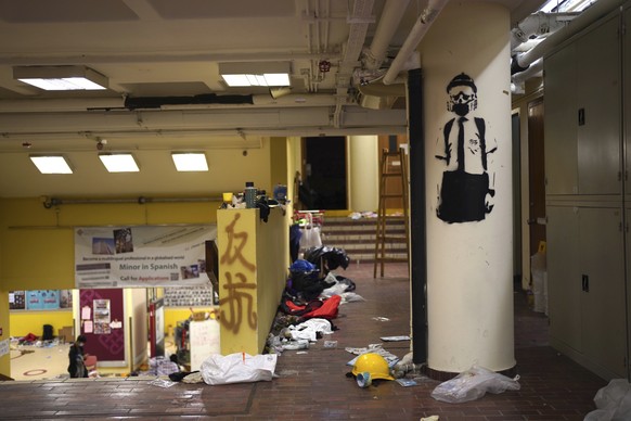 Debris and graffiti is seen inside Hong Kong Polytechnic University in Hong Kong, early Wednesday, Nov. 20, 2019. A small band of anti-government protesters, their numbers diminished by surrenders and ...