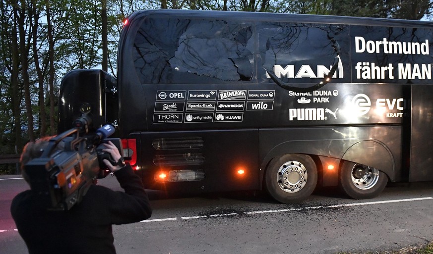 A camera man films Dortmund&#039;s team bus after it was damaged in an explosion before the Champions League quarterfinal soccer match between Borussia Dortmund and AS Monaco in Dortmund, western Germ ...