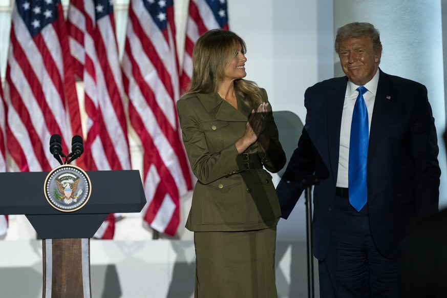 President Donald Trump joins first lady Melania Trump on stage after her speech to the 2020 Republican National Convention from the Rose Garden of the White House, Tuesday, Aug. 25, 2020, in Washingto ...
