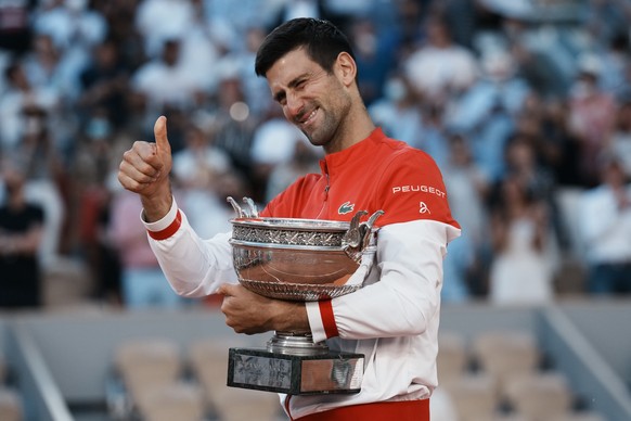 Serbia&#039;s Novak Djokovic thumbs up with the cup after defeating Stefanos Tsitsipas of Greece in their final match of the French Open tennis tournament at the Roland Garros stadium Sunday, June 13, ...