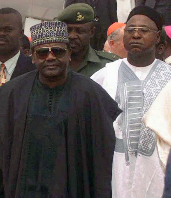 FILE - In this file photo taken on Saturday, March 21, 1998, late Nigeria President Gen. Sani Abacha, left, attends an event in Abuja, Nigeria. Liechtenstein is returning $227 million looted by Nigeri ...