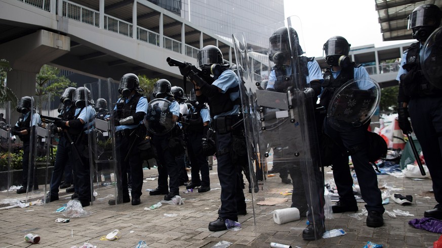 epa07643086 Police prepare to shoot tear gas at protesters during a rally against an extradition bill outside the Legislative Council in Hong Kong, China, 12 June 2019. The bill has faced immense oppo ...