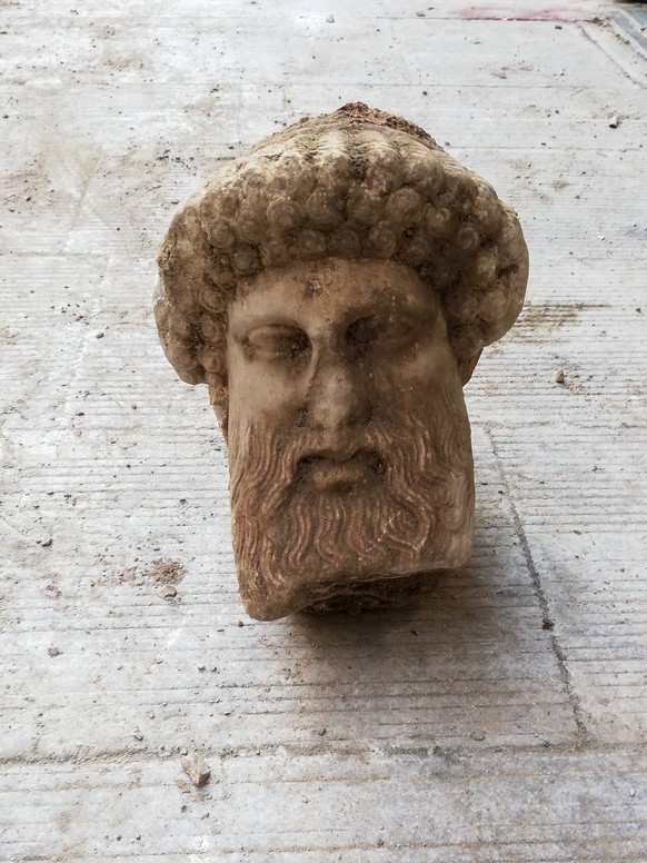 In this undated photo, provided by the Greek Culture Ministry on Sunday, Nov. 15, 2020, a head of the ancient god Hermes is pictured after being found during sewage works in central Athens. The minist ...