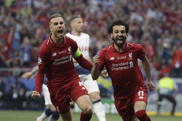 Liverpool&#039;s Mohamed Salah, right, celebrates after scoring his side&#039;s opening goal during the Champions League final soccer match between Tottenham Hotspur and Liverpool at the Wanda Metropo ...