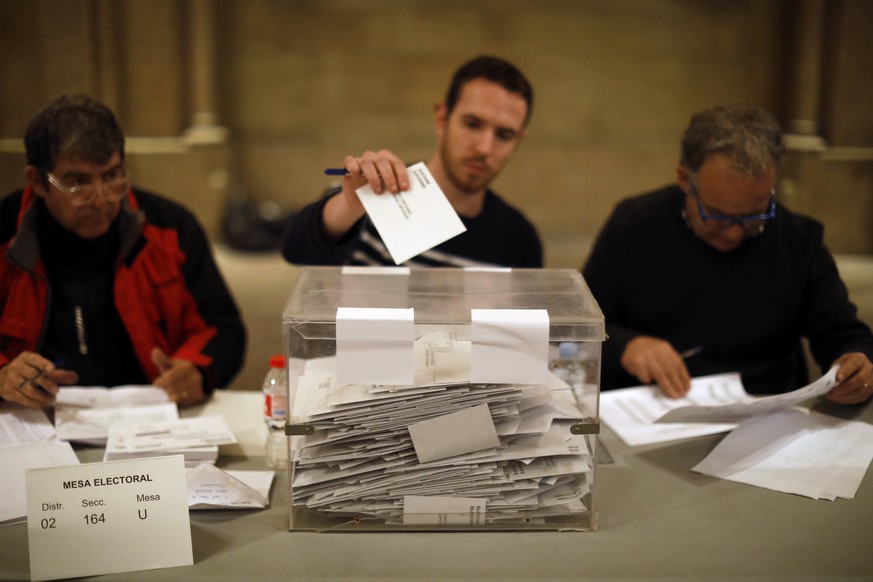 As polls close, election workers cast their own ballots for the Catalan regional election in a polling station at the Barcelona University in Barcelona, Spain, on Thursday, Dec. 21, 2017. Catalans are ...