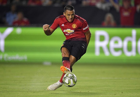 Manchester United forward Alexis Sanchez kicks a goal during the first half of an International Champions Cup tournament soccer match against AC Milan Wednesday, July 25, 2018, in Carson, Calif. (AP P ...