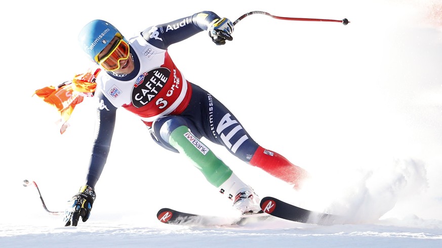 Christof Innerhofer of Italy speeds down with a part of a gate that remained entrapped in his race glasses during the men&#039;s downhill race at the Alpine Skiing World Cup in Santa Caterina Valfurva ...