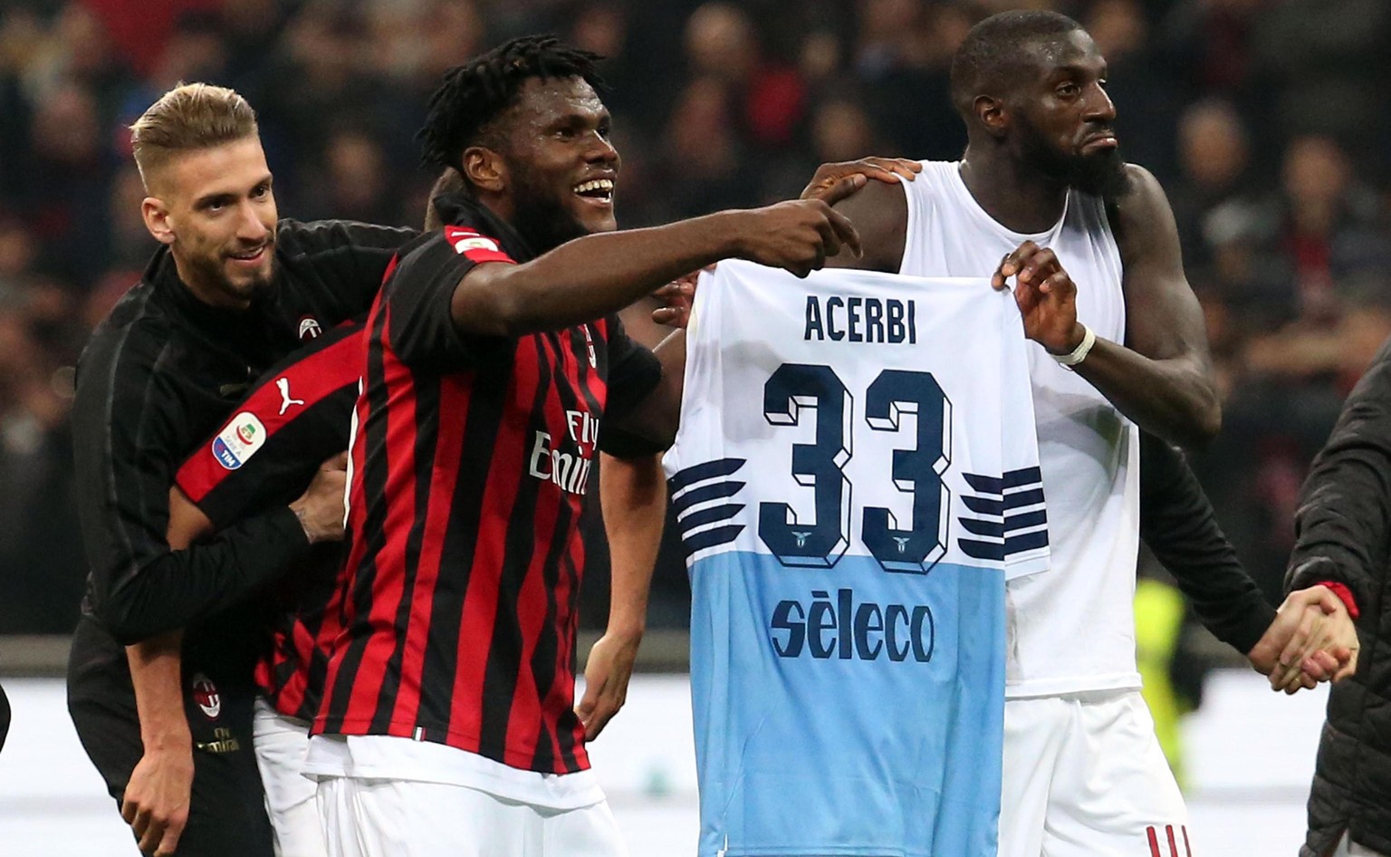epa07504840 AC Milan&#039;s Franck Kessie (L) and his teammate Tiemoue Bakayoko hold a Lazio jersey at the end of the Italian Serie A soccer match between AC Milan and SS Lazio at Giuseppe Meazza stad ...