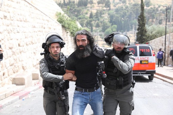 epa09188824 Israeli police arrest a Palestinian man at the Lions&#039; Gate, as clashes continue at the Temple Mount in the old city of Jerusalem, 10 May 2021. Protests continue in support of six Pale ...