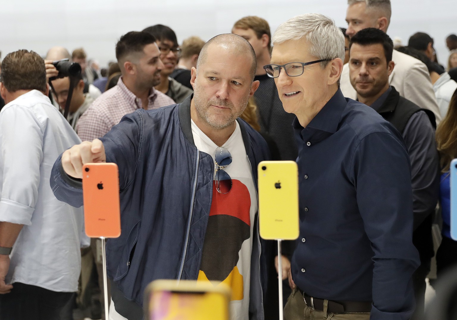Jonathan Ive, Apple&#039;s chief design officer, left, looks at some new iPhone models with CEO Tim Cook during an event to announce new products Wednesday, Sept. 12, 2018, in Cupertino, Calif. (AP Ph ...