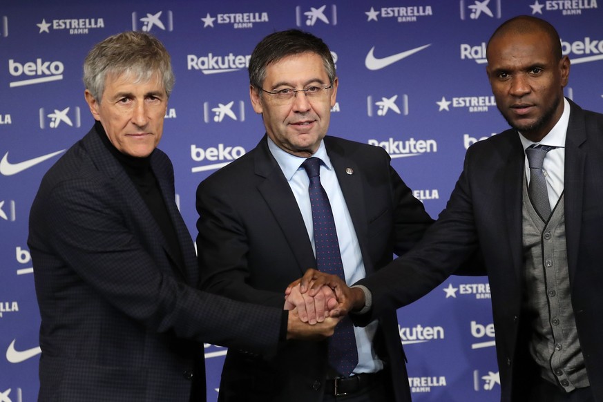 Soccer coach Quique Setien poses with FC Barcelona&#039;s President Josep Maria Bartomeu, center, and director of football Eric Abidal, right, while being officially introduced as the club&#039;s new  ...