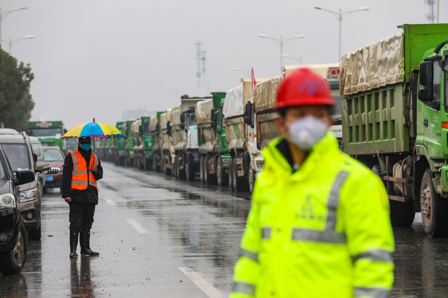 epa08157641 People work at the construction site of a field hospital in Wuhan, Hubei province, China, 24 January 2020. The 1,000-bed hospital is expected to be completed by 03 February 2020 to cope wi ...