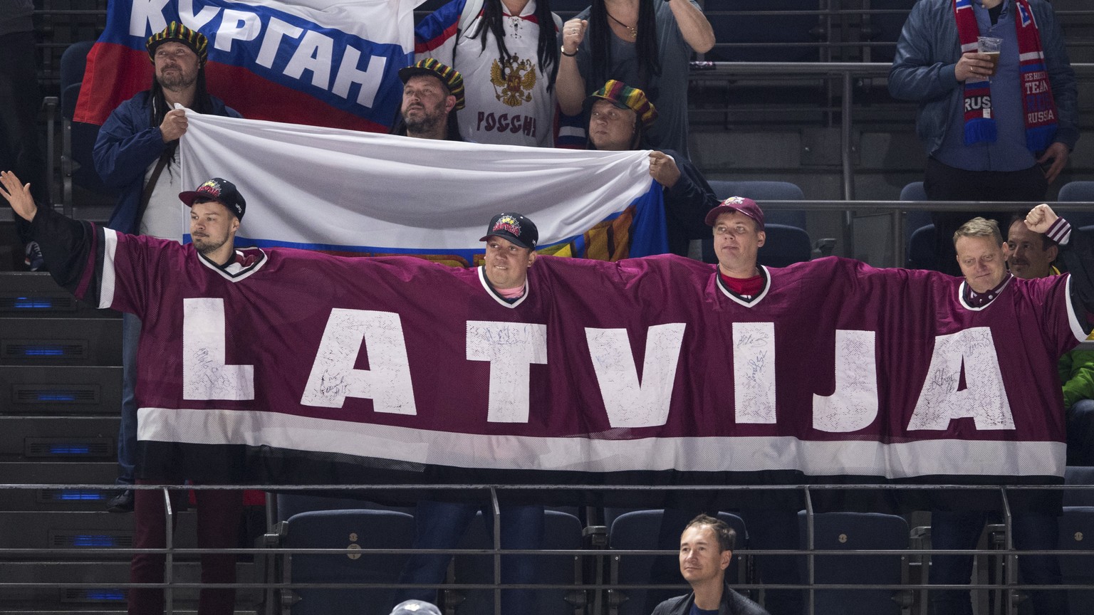 Latvia ice hockey team fans encourage their team during the IIH World Championship group A ice hockey match between Russia and Latvia at the Lanxess Arena in Cologne, Germany, Monday May 15, 2017. (Ma ...