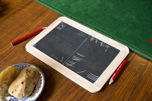 A slate to keep track of the points made during the traditional Swiss card game &quot;Jassen&quot; lies on a table at the restaurant Ochsen in Luetzelflueh in the canton of Berne, Switzerland, picture ...