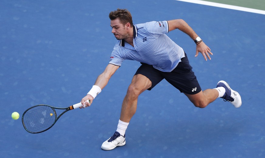 epa07815462 Stan Wawrinka of Switzerland hits a return to Daniil Medvedev of Russia during their quarter-finals round match on the ninth day of the US Open Tennis Championships the USTA National Tenni ...