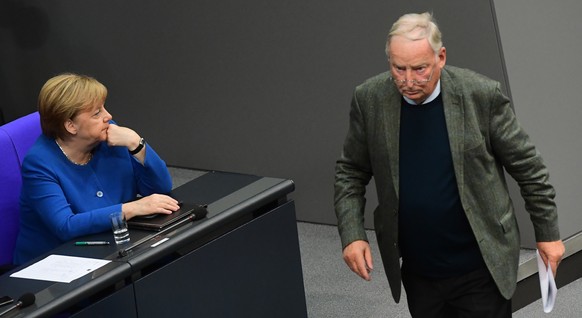 epa07926661 Alternative fuer Deutschland party (AfD) faction co-chairman in the German parliament Bundestag Alexander Gauland (R) passes-by German Chancellor Angela Merkel (L) After his speech to the  ...