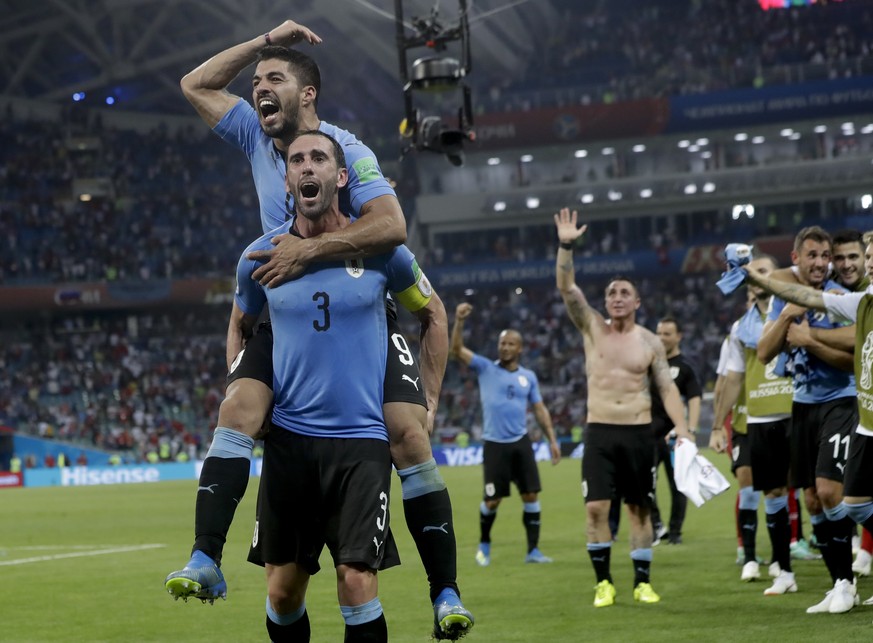 Uruguay&#039;s Luis Suarez, above, and Diego Godin celebrate after the round of 16 match between Uruguay and Portugal at the 2018 soccer World Cup at the Fisht Stadium in Sochi, Russia, Saturday, June ...
