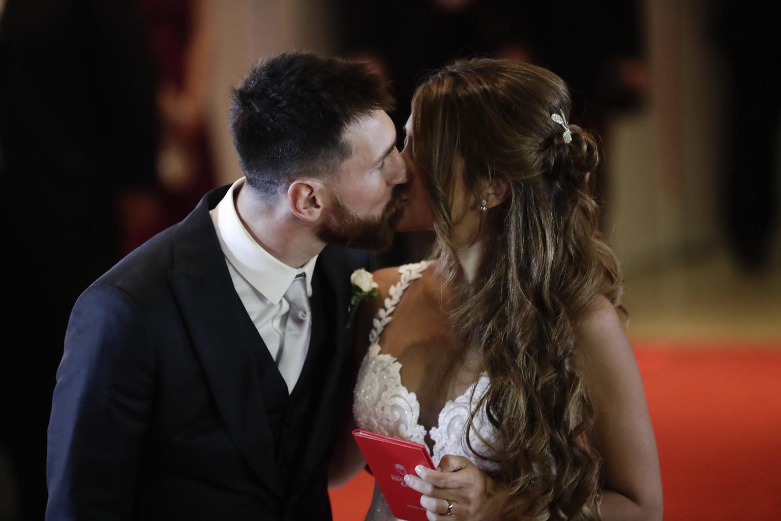 Newlyweds Lionel Messi and Antonella Roccuzzo kiss while posing for photographers on the red carpet after tying the knot in Rosario, Argentina, Friday, June 30, 2017. About 250 guests, including teamm ...