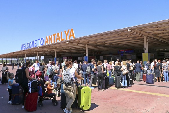 British passengers with Thomas Cook wait in long queue at Antalya airport in Antalya, Turkey, Monday Sept. 23, 2019. Hundreds of thousands of travellers were stranded across the world Monday after Bri ...