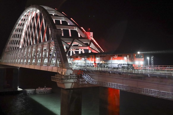A passenger train from Russia crosses a bridge linking Russia and the Crimean peninsula Wednesday, Dec. 25, 2019. Ukrainian officials opened a criminal probe Wednesday after a passenger train from Rus ...