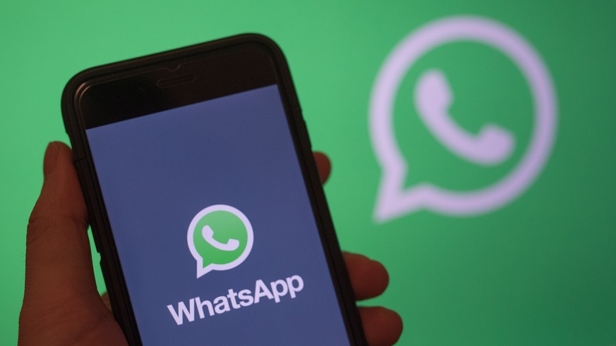 epa07568740 epa07306542 (FILE) - A smart phone screen shows the logo of WhatsApp application in Berlin, Germany, 31 December 2017 (reissued 14 May 2019). Facebook&#039;s messenger service WhatsApp has ...