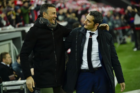 FILE- In this Thursday, Jan.5, 2017 file photo, Barcelona&#039;s manager Luis Enrique, left smiles beside Athletic Bilbao&#039;s manager Ernesto Valverde, during the Spanish Copa del Rey, 16 round, fi ...