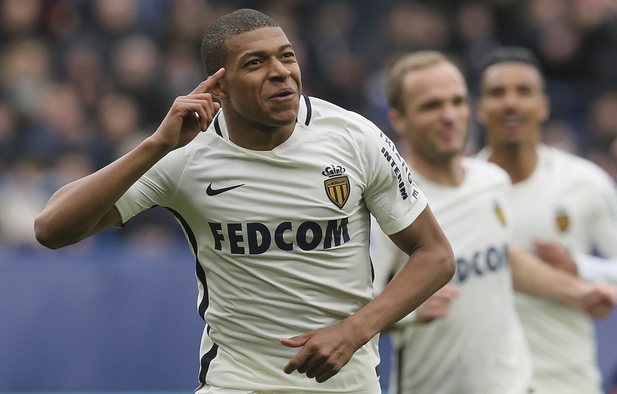FILE - In this March 19, 2017, file photo, Monaco&#039;s Kylian Mbappe celebrates with teammates after he scored the first goal during their French League One soccer match against Caen, in Caen, north ...