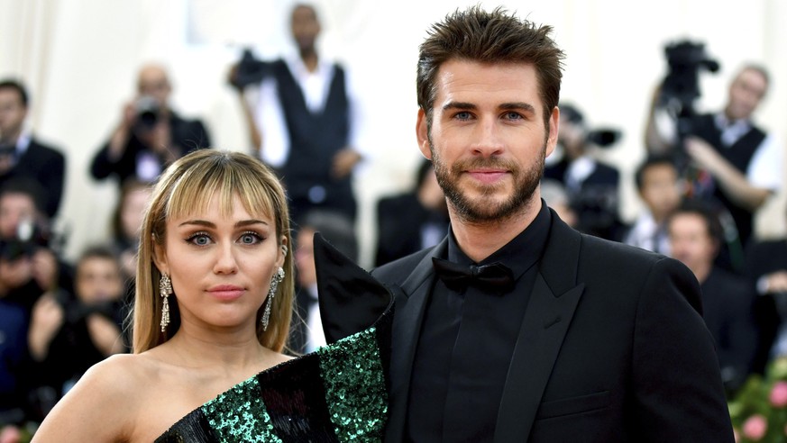 FILE - In this May 6, 2019 file photo, Miley Cyrus, left, and Liam Hemsworth attend The Metropolitan Museum of Art&#039;s Costume Institute benefit gala celebrating the opening of the &quot;Camp: Note ...