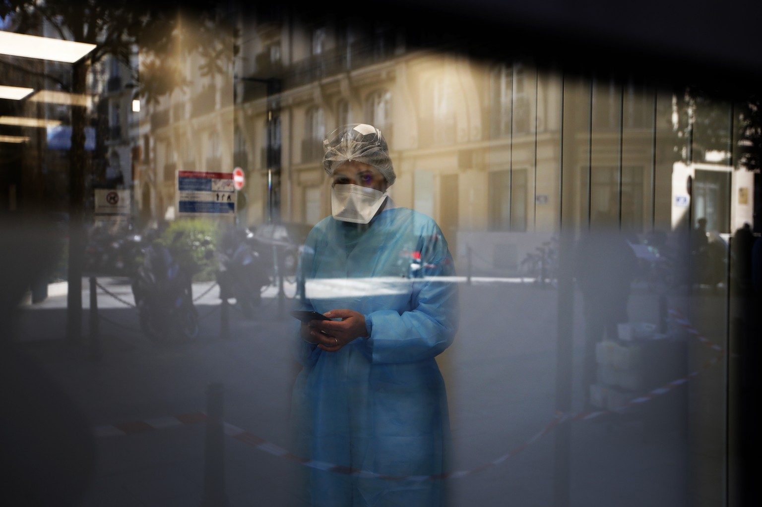 Biologist doctor Caroline Gutsmuth gives a phone call in medical biology laboratory who opened a coronavirus drive-thru testing site, in Neuilly-sur-Seine, near Paris, March 23, 2020. (AP Photo/Christ ...