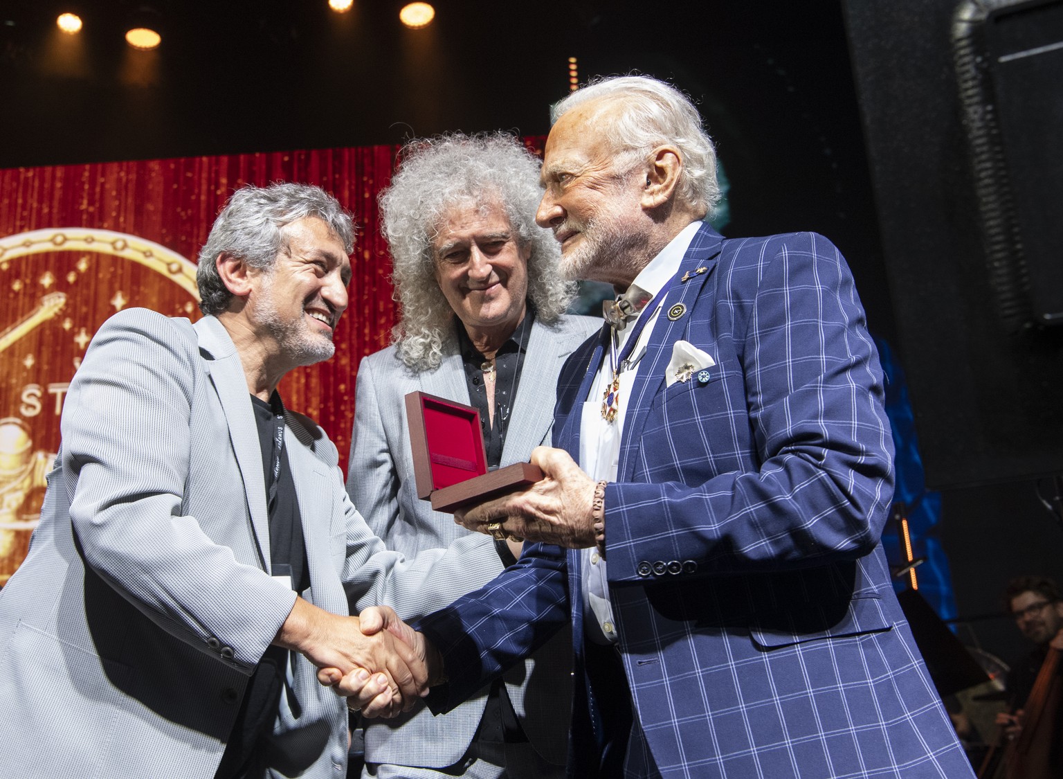 Astronaut Buzz Aldrin, right, receives the Lifetime Achievement Award of Stephen Hawking Medal for Science Communication from Garik Israelian, Starmus Founding Diector, left, and Musician Brian May, c ...