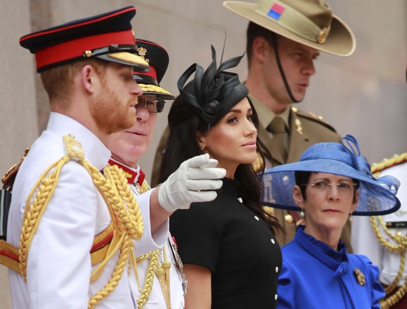 In this Oct. 20, 2018, photo, Britain&#039;s Prince Harry, left, and his wife Meghan, center, the Duchess of Sussex attend the opening of Anzac Memorial at Hyde Park in Sydney, Australia. Prince Harry ...